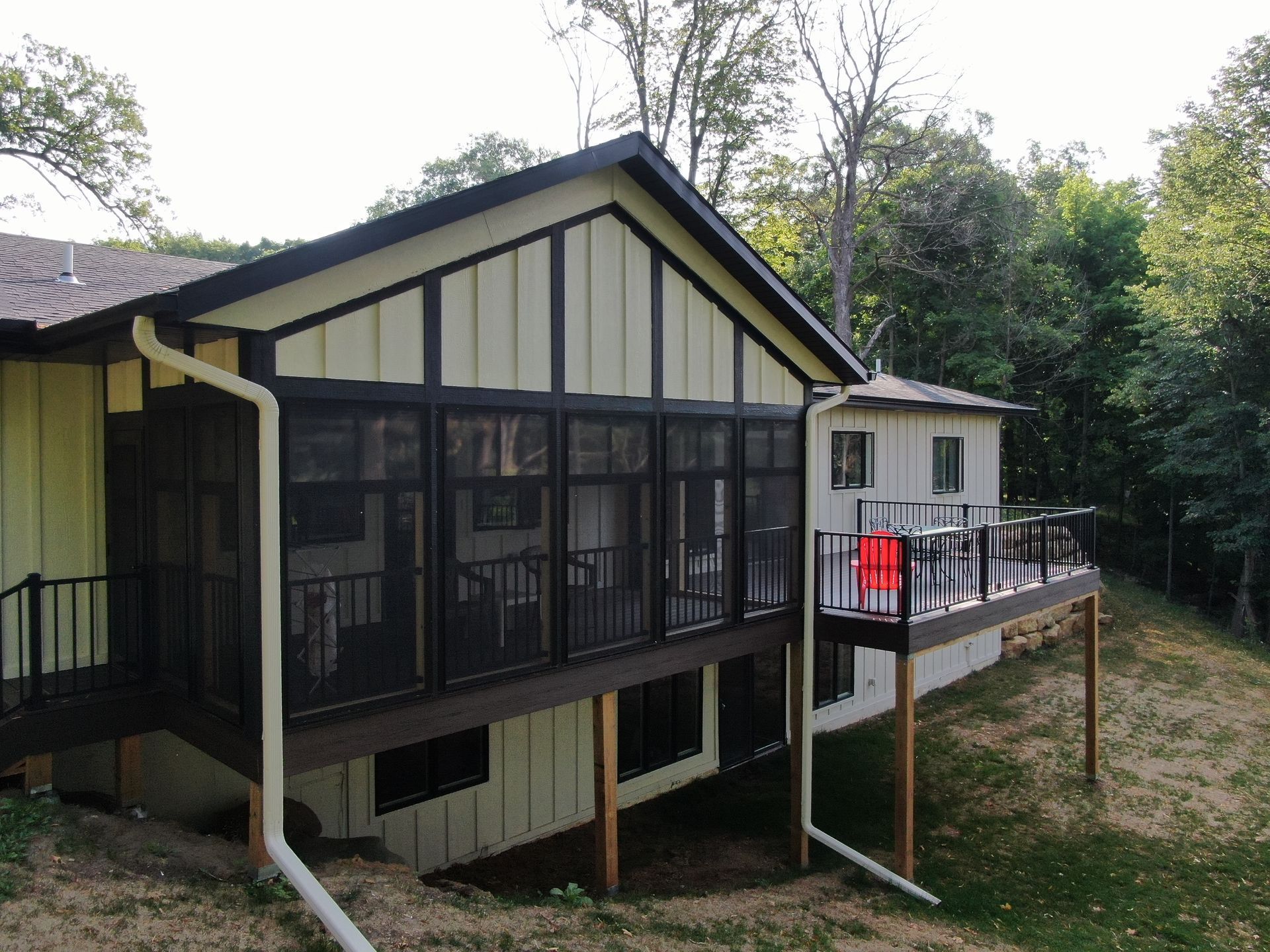 A house with a screened in porch and a deck