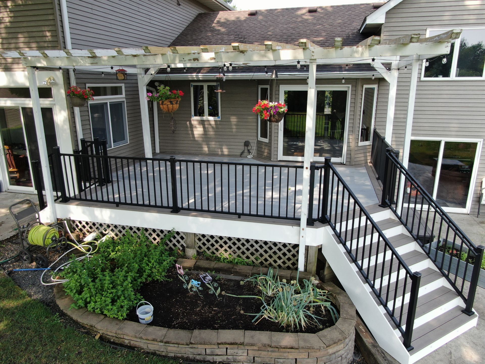 An aerial view of a deck with stairs and a pergola.