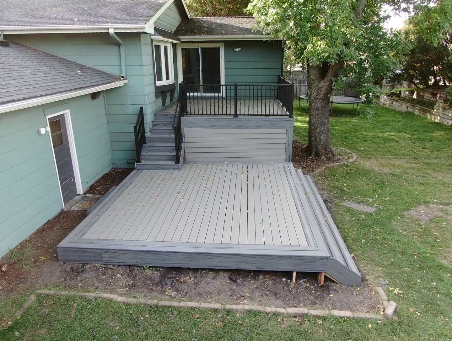 An aerial view of a deck in front of a house