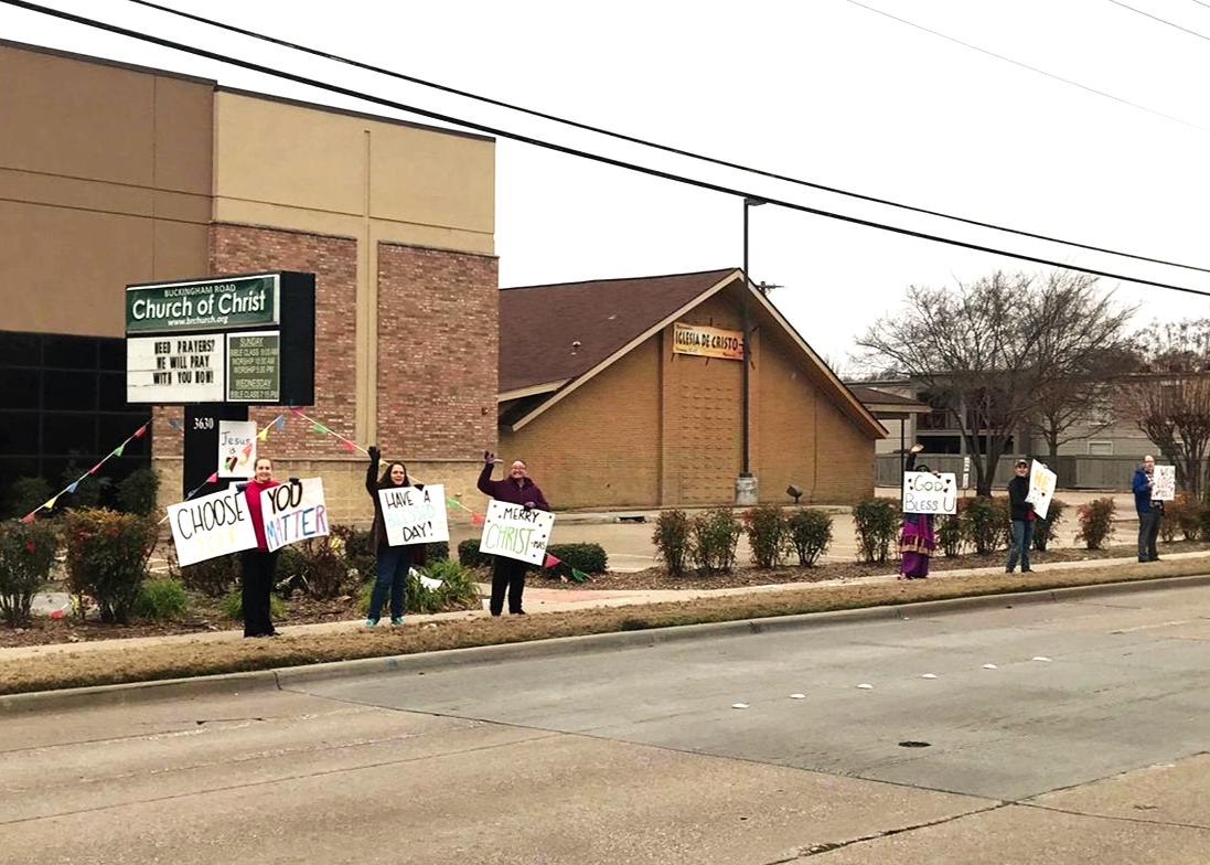Church members sharing signs of encouragement