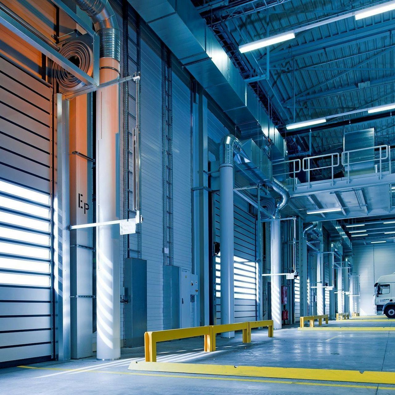 A large warehouse with a yellow barrier in the middle for Fraser Corporate Finance.