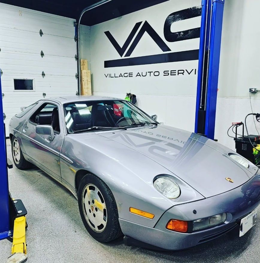 A silver Porsche is parked in our Ancaster auto repair shop for diagnostics and routine maintenance