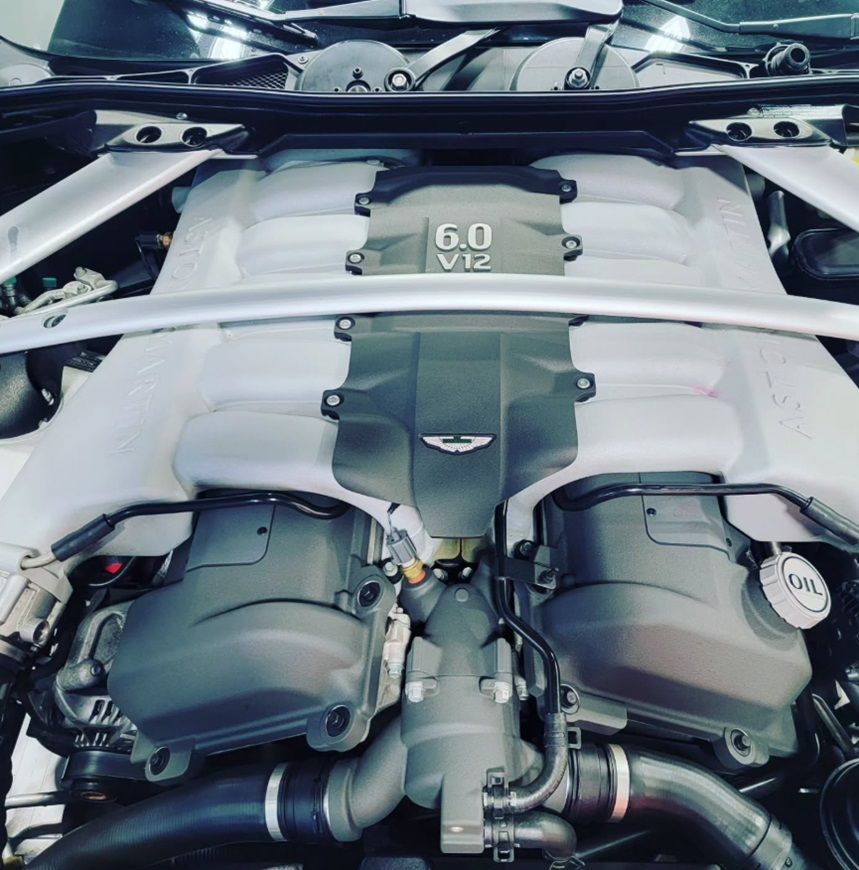 The exposed engine of an Aston Martin in for repairs at our shop in Ancaster