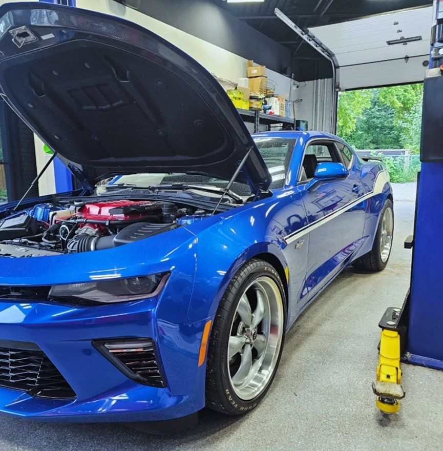 A blue Chevrolet Camaro in our auto repair shop for engine repair service