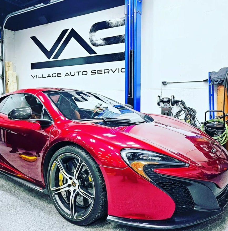 A red McLaren parked in our Ancaster shop for auto repairs