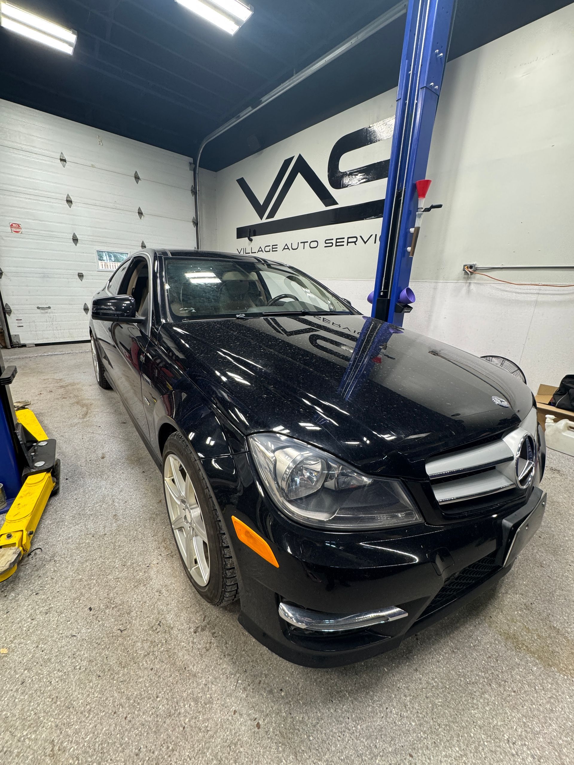 A black Mercedes parked in our shop for repair service