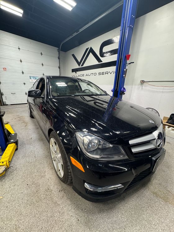 A black Mercedes parked in our shop for repair service