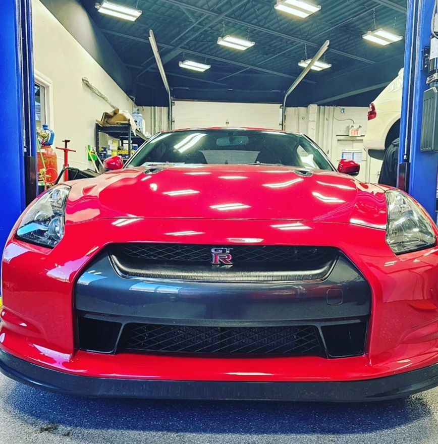 A Nissan parked inside Village Auto Service for repair