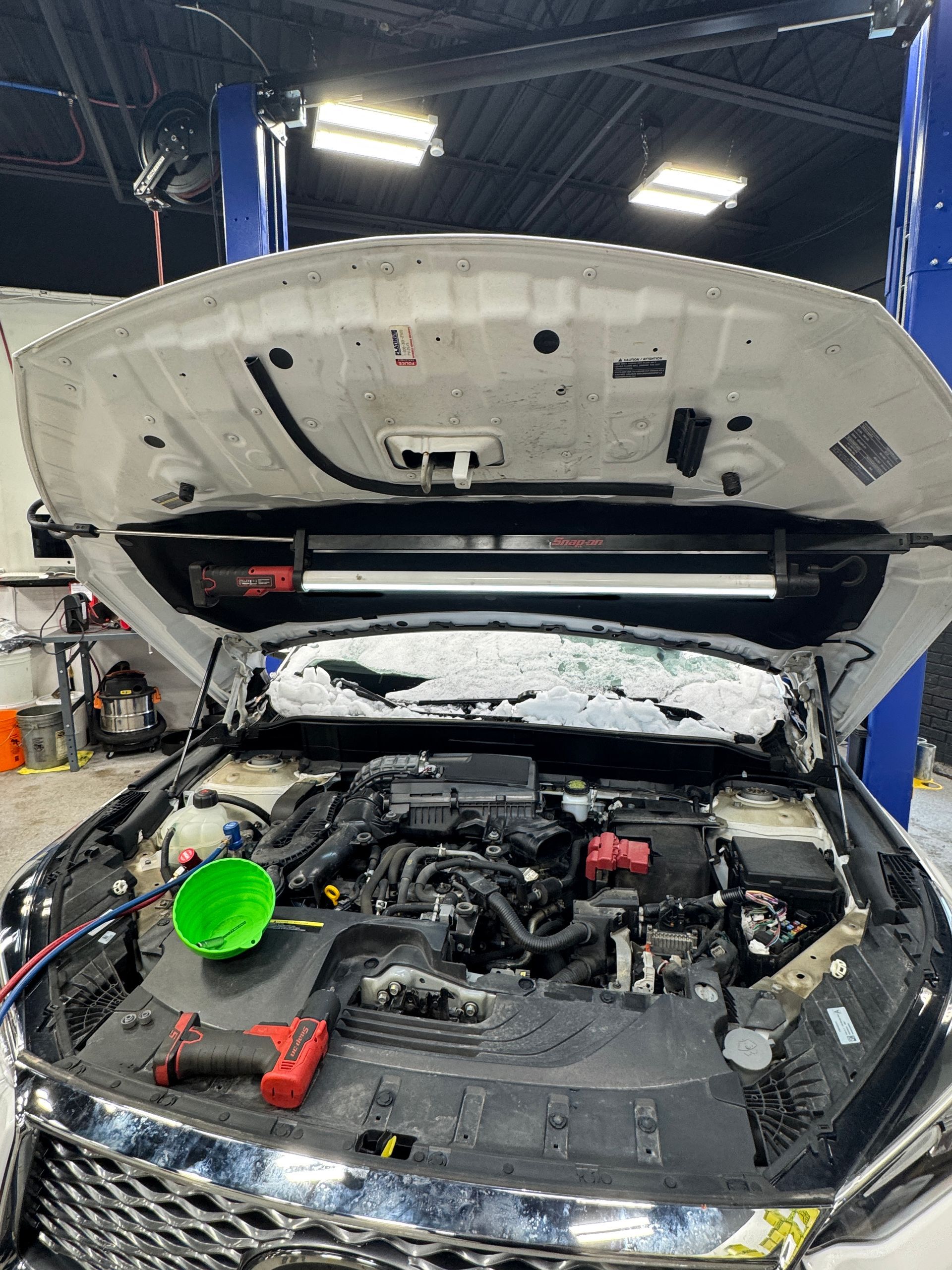 A car is getting an oil and filer change at Village Auto Service