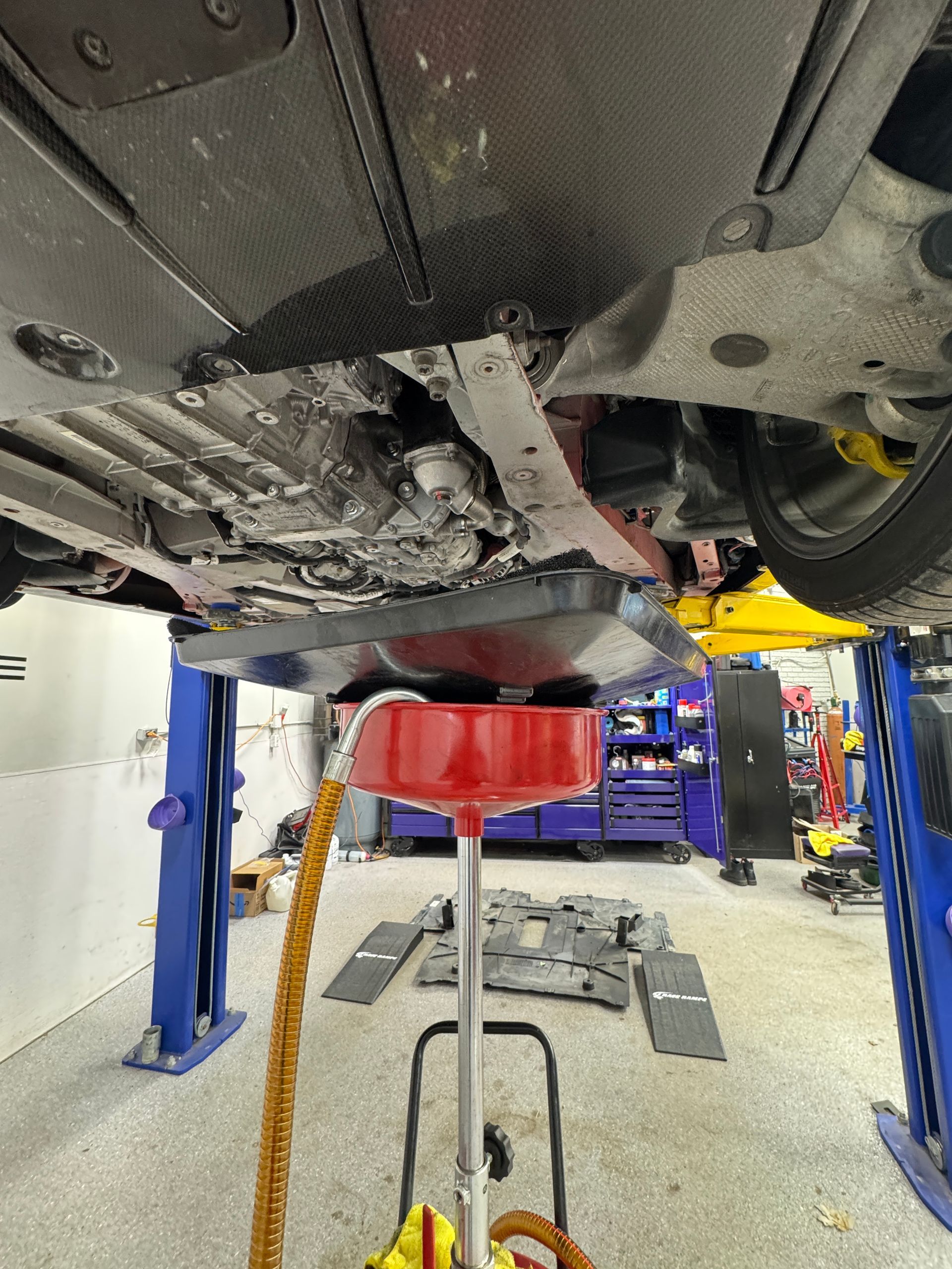 A car suspended in our Ancaster auto shop getting a synthetic oil and filter change