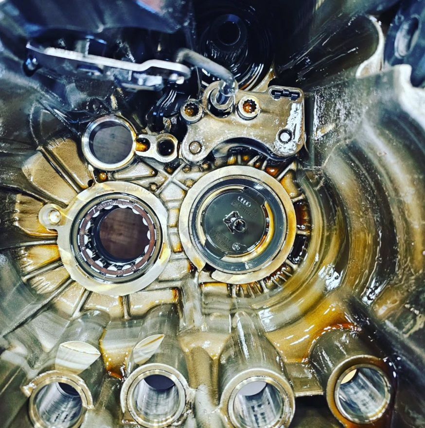 A close up view of the working components of a vehicle transmission during repair at Village Auto Service