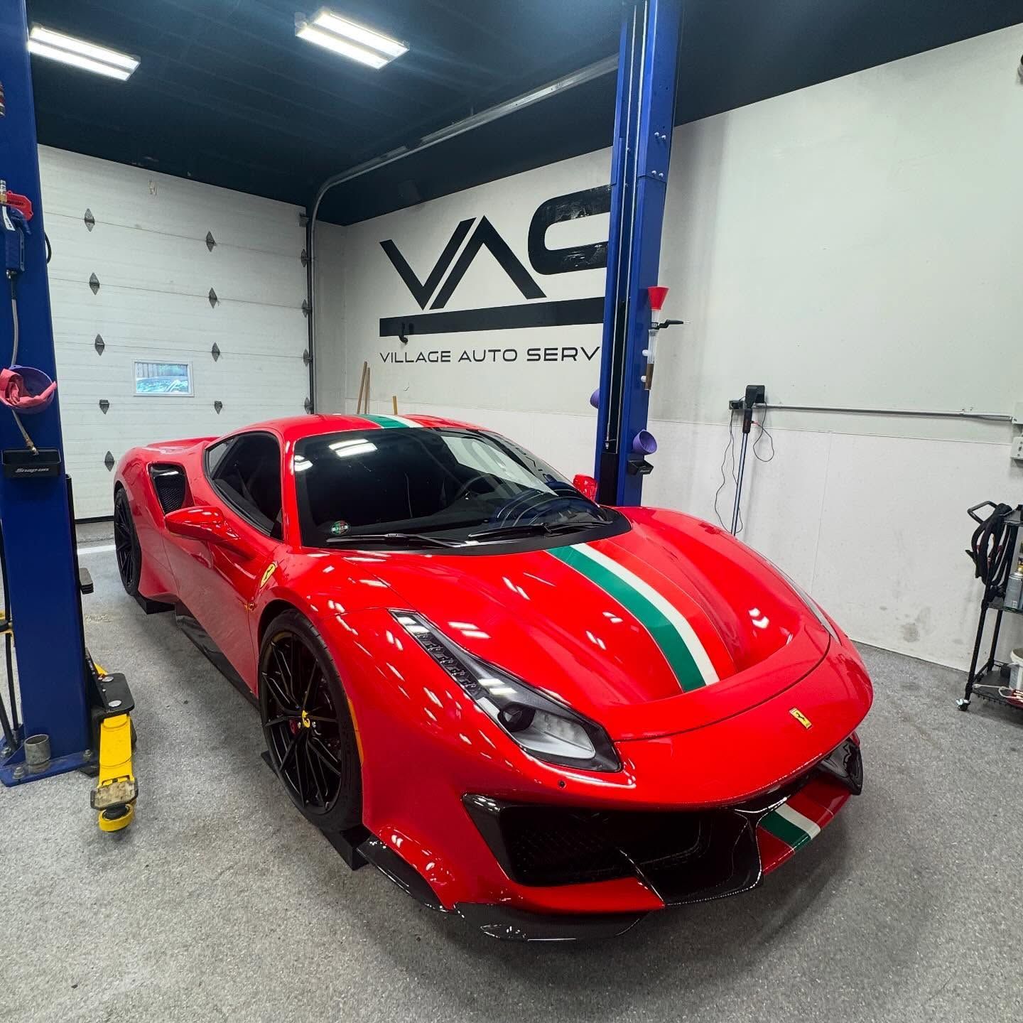 Consider your car cared for expertly like this magnificent Ferrari. Red Ferrari parked inside Village Auto Service for auto maintenance.