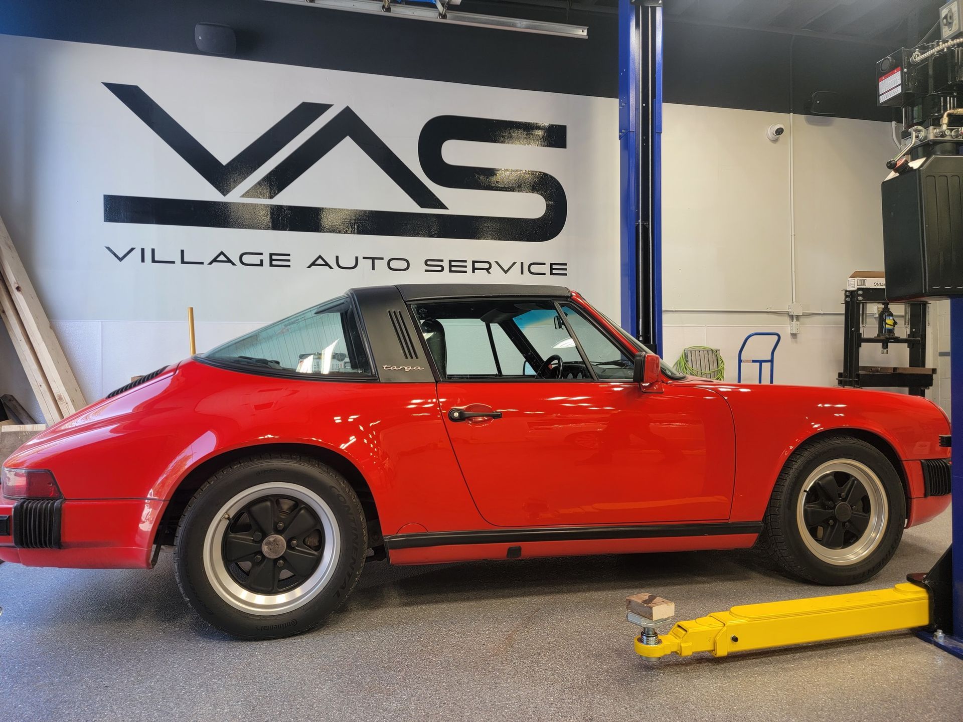 Red Porsche in Village Auto Service for maintenance and repair