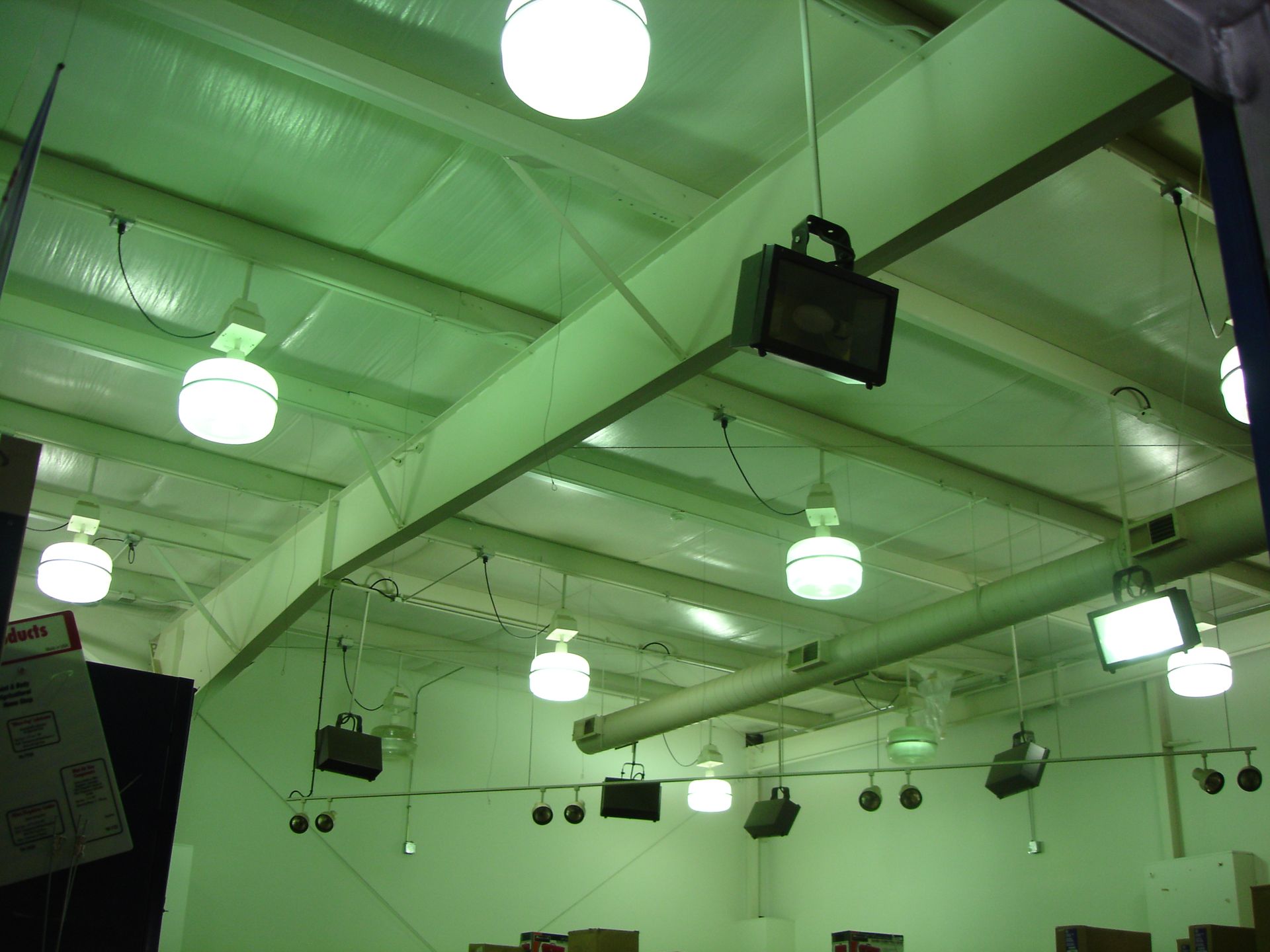 A large room with lots of lights hanging from the ceiling