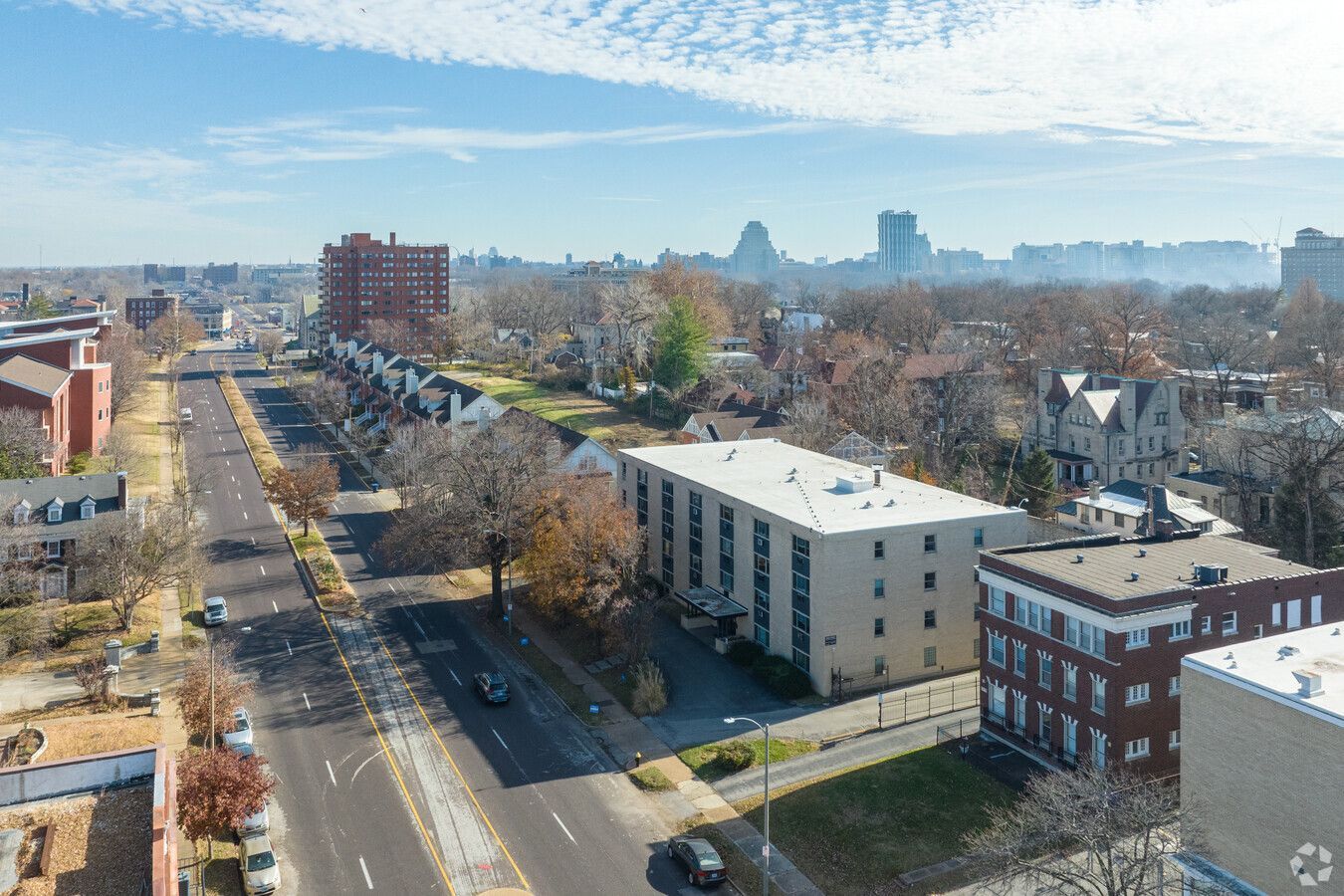 An aerial view of a city street and buildings on a sunny day.