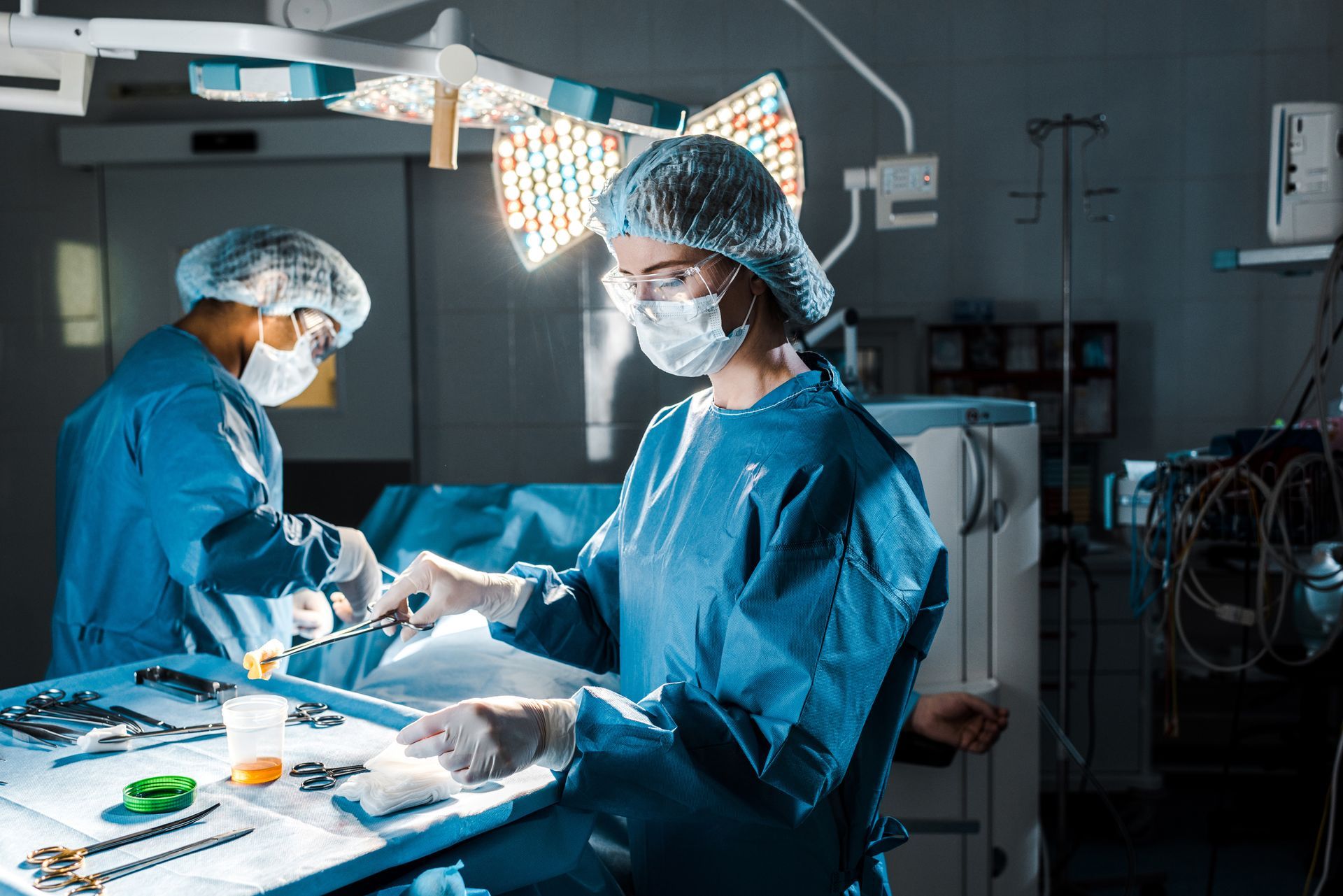 Two surgeons are operating on a patient in an operating room.