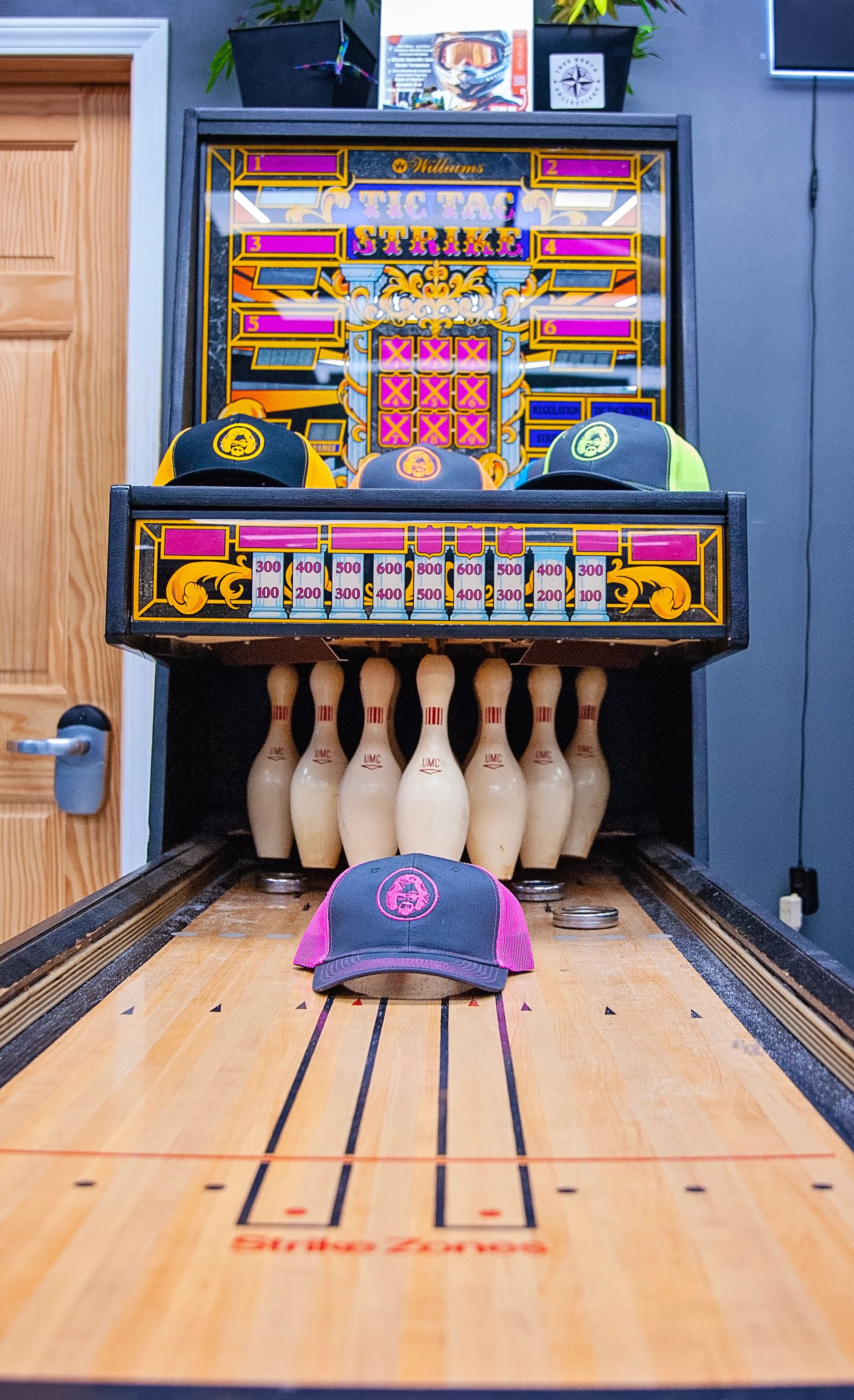 A bowling alley with bowling pins and hats on it.