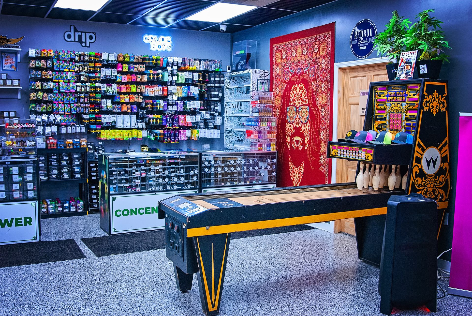 A bowling alley in a store with a table in the middle