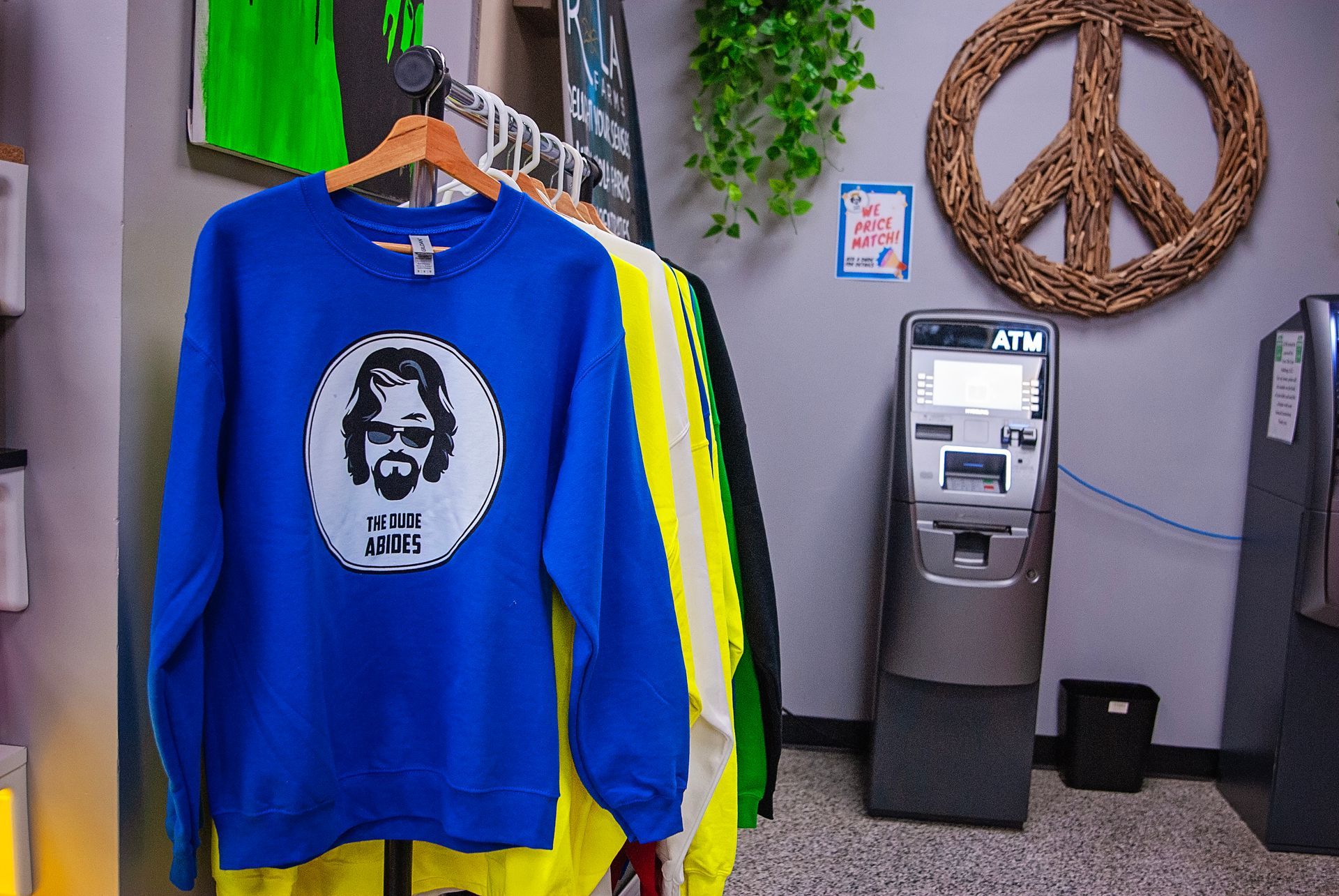 A blue sweatshirt with a peace sign on the wall