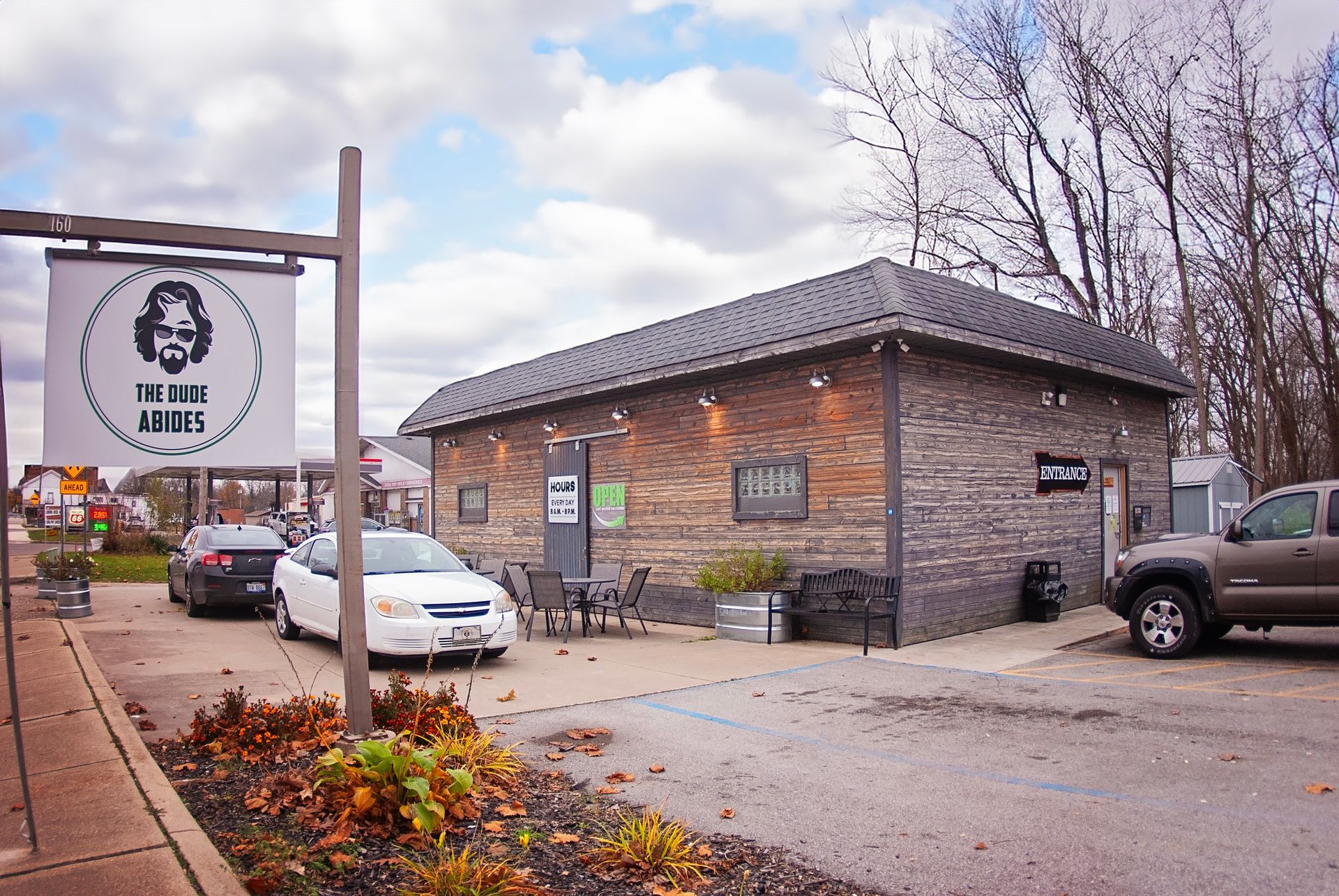 A white car is parked in front of a building
