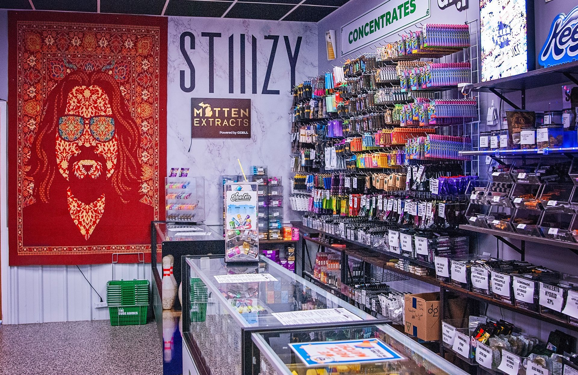 A store filled with lots of products and a painting of a man on the wall.