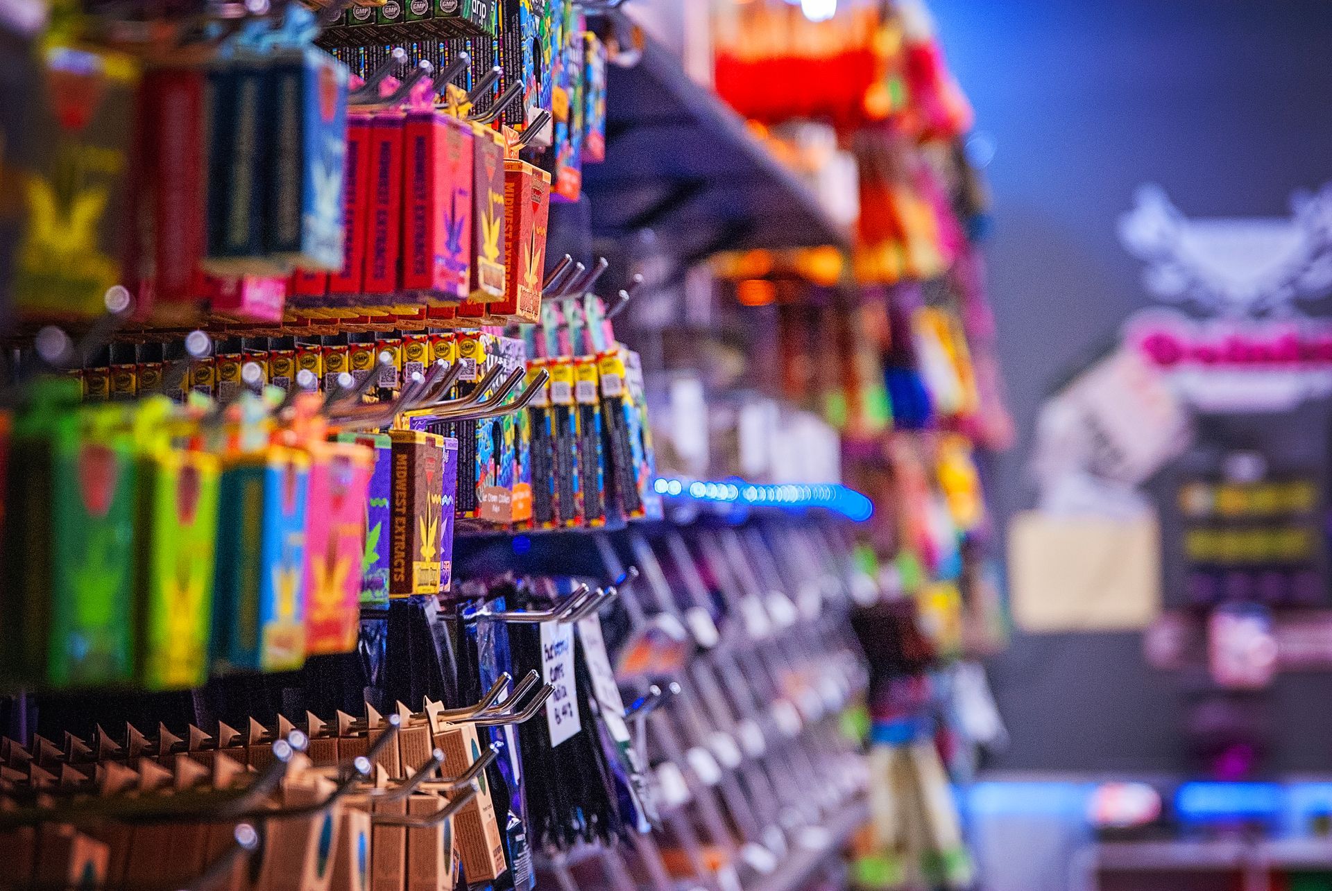 A row of shelves filled with lots of colorful items in a store.