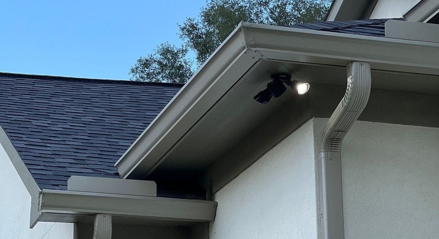 a gutter on the side of a house with a light on it