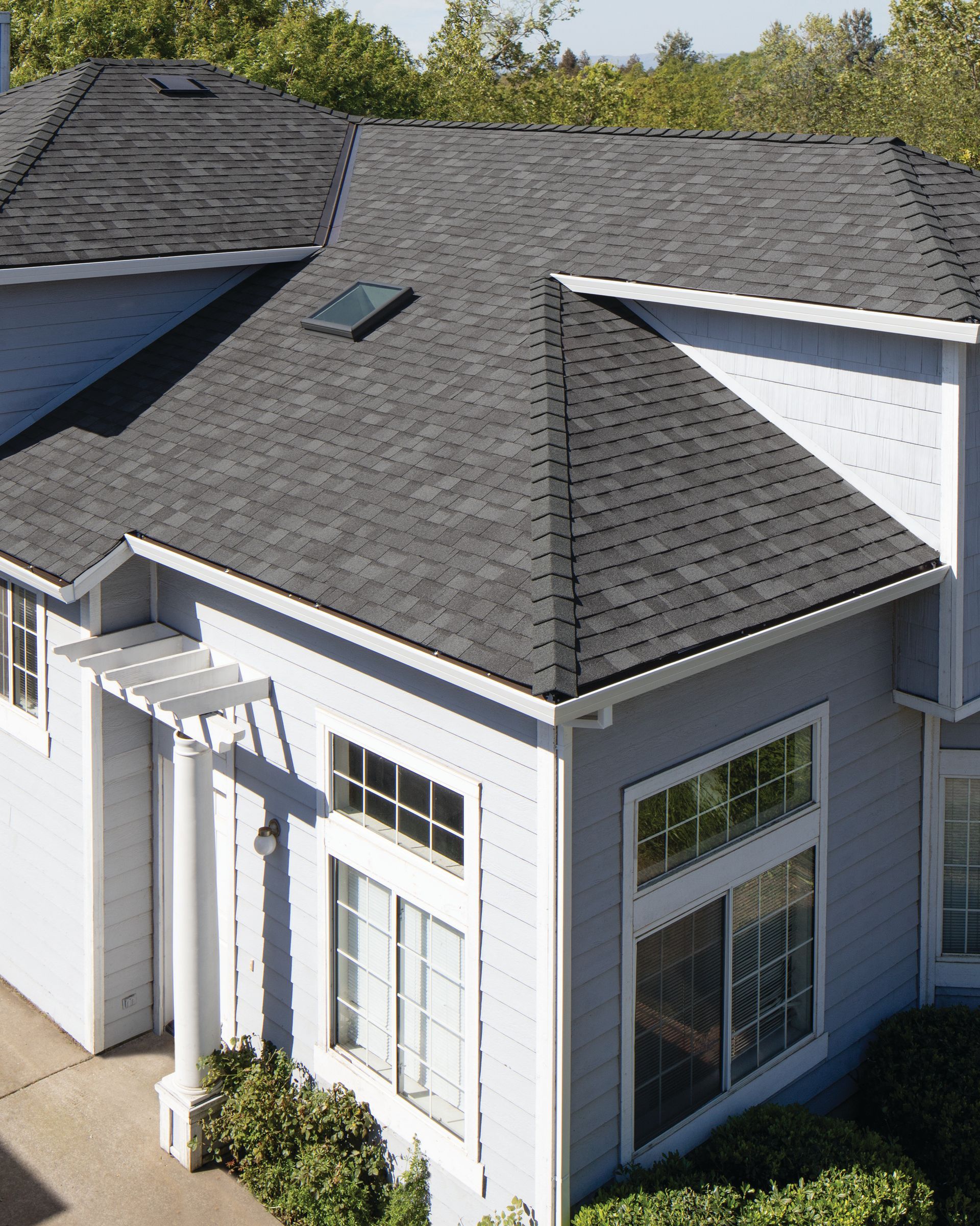 An aerial view of a house with a black roof