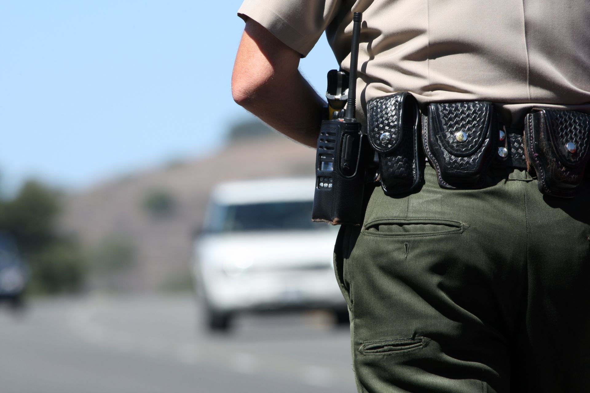 a police officer is standing in front of a white van