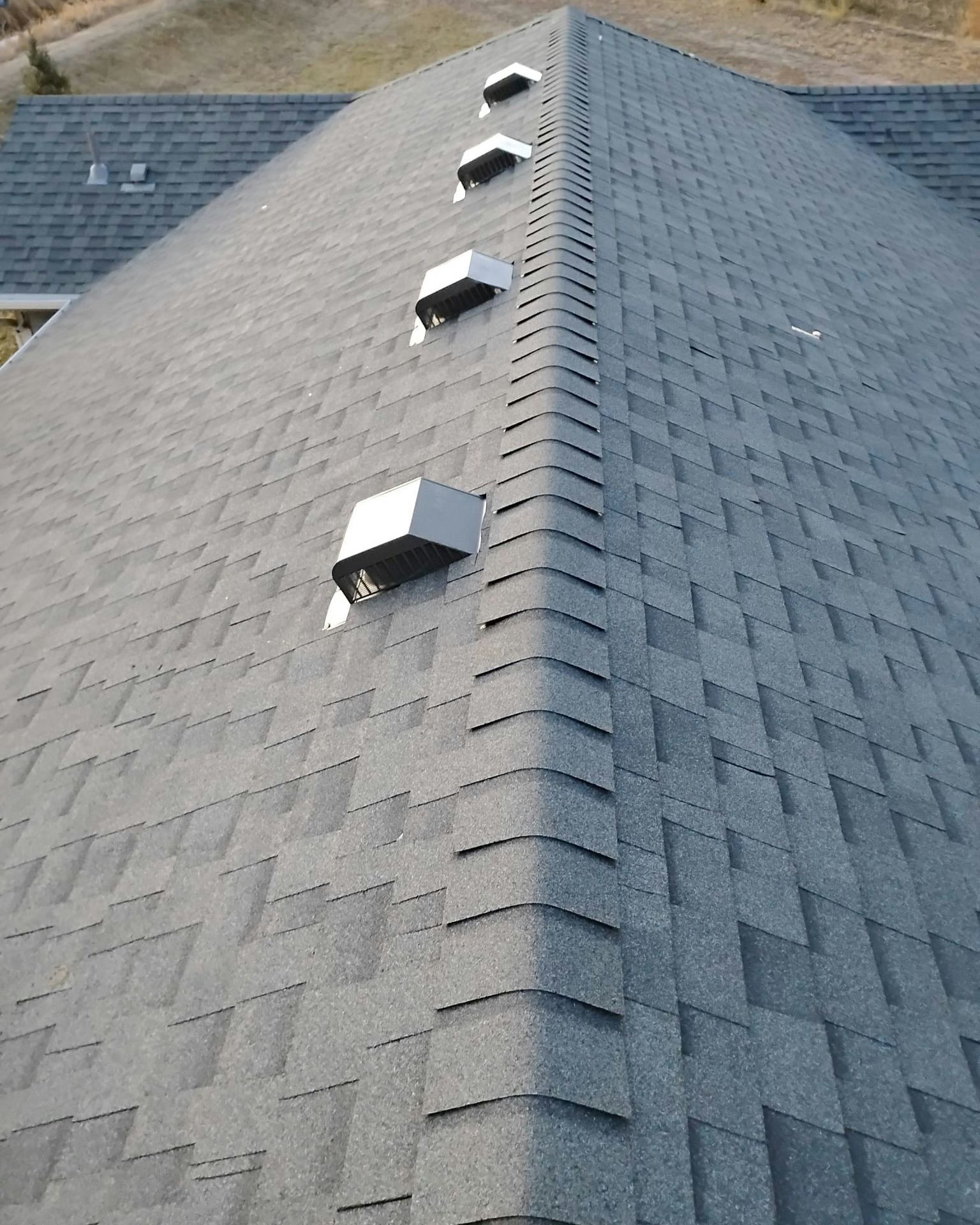 A close up of a roof with a lot of vents on it.