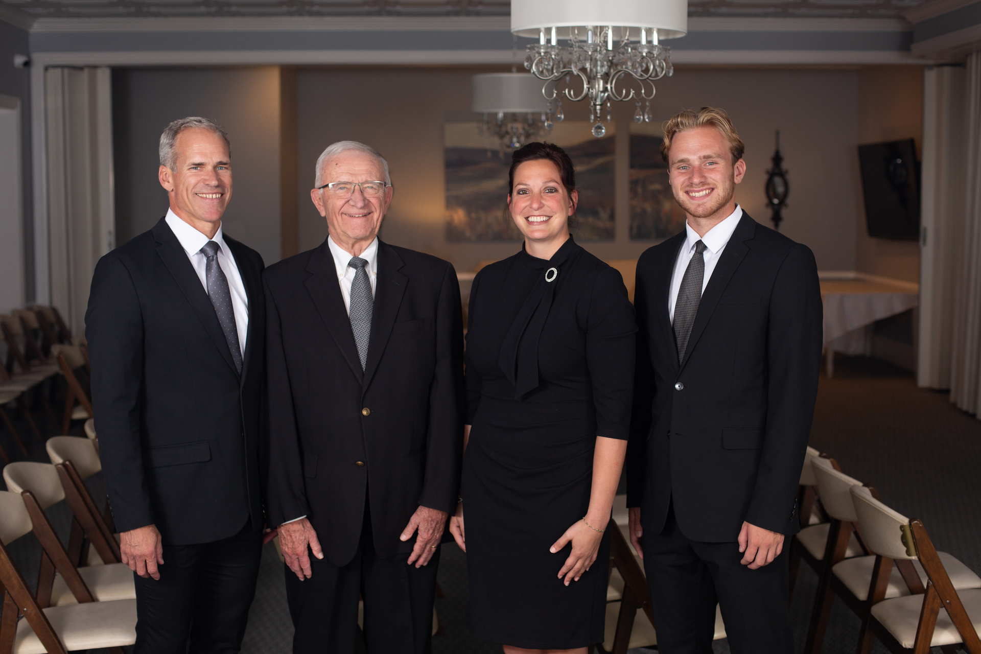 A man and a woman are sitting next to each other looking at a lake.