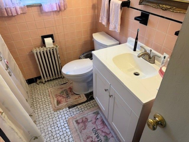 Small pink bathroom with white vanity after new white vanity and toilet installed by steen & son plumbing and heating in mays landing, new jersey