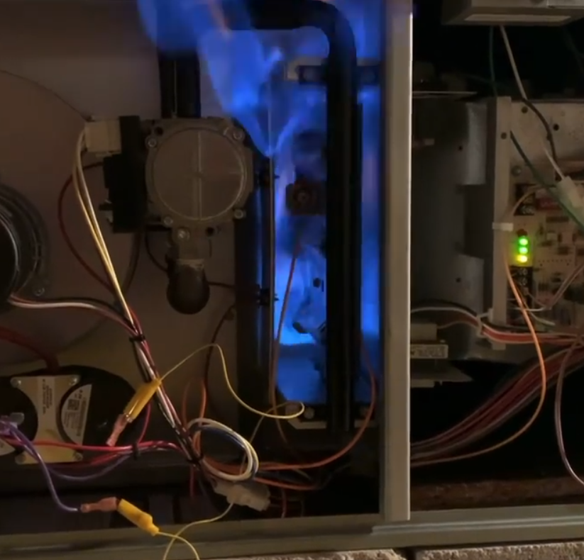 a furnace flame roll out being performed by Steen & Son Plumbing and Heating in Mays Landing, New Jersey