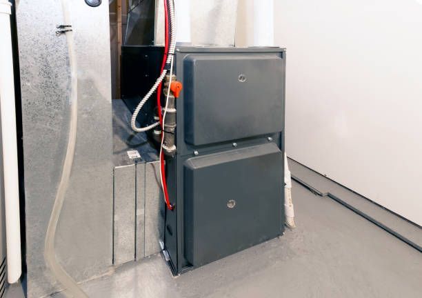 Basement heating system with grey furnace for home and business heating repair
