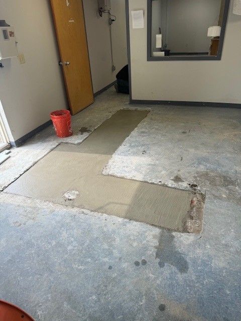 New concrete poured over trench in an office room after new water pipe installed by steen & son plumbing and heating in mays landing, new jersey