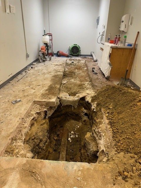 steen & son plumbing and heating excavating a concrete floor to fix plumbing pipe