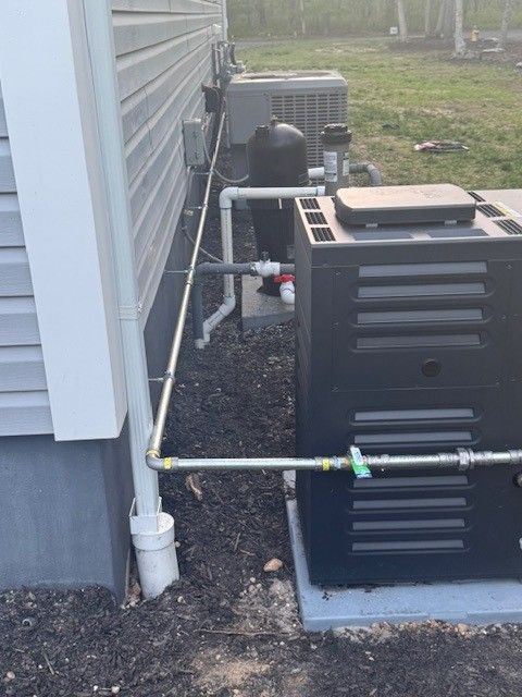 Exterior of a building with HVAC units with a new gas line connected for a pool heater installed by steen & son plumbing and heating
