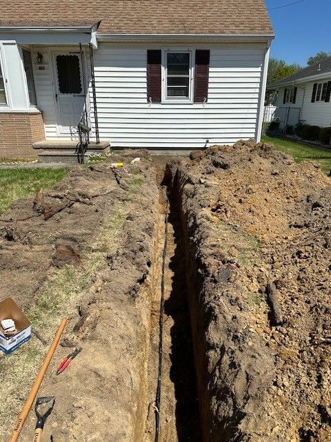 Trench dug in front of a white house in mays landing, new jersey for new underground water line installed by steen & son plumbing and heating