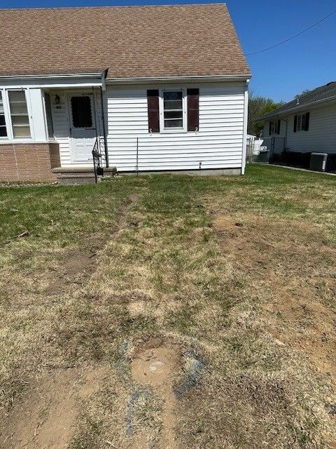 White house with brown roof and brown shutter with ground repaired after installing new water line by steen & son plumbing and heating in mays landing, new jersey