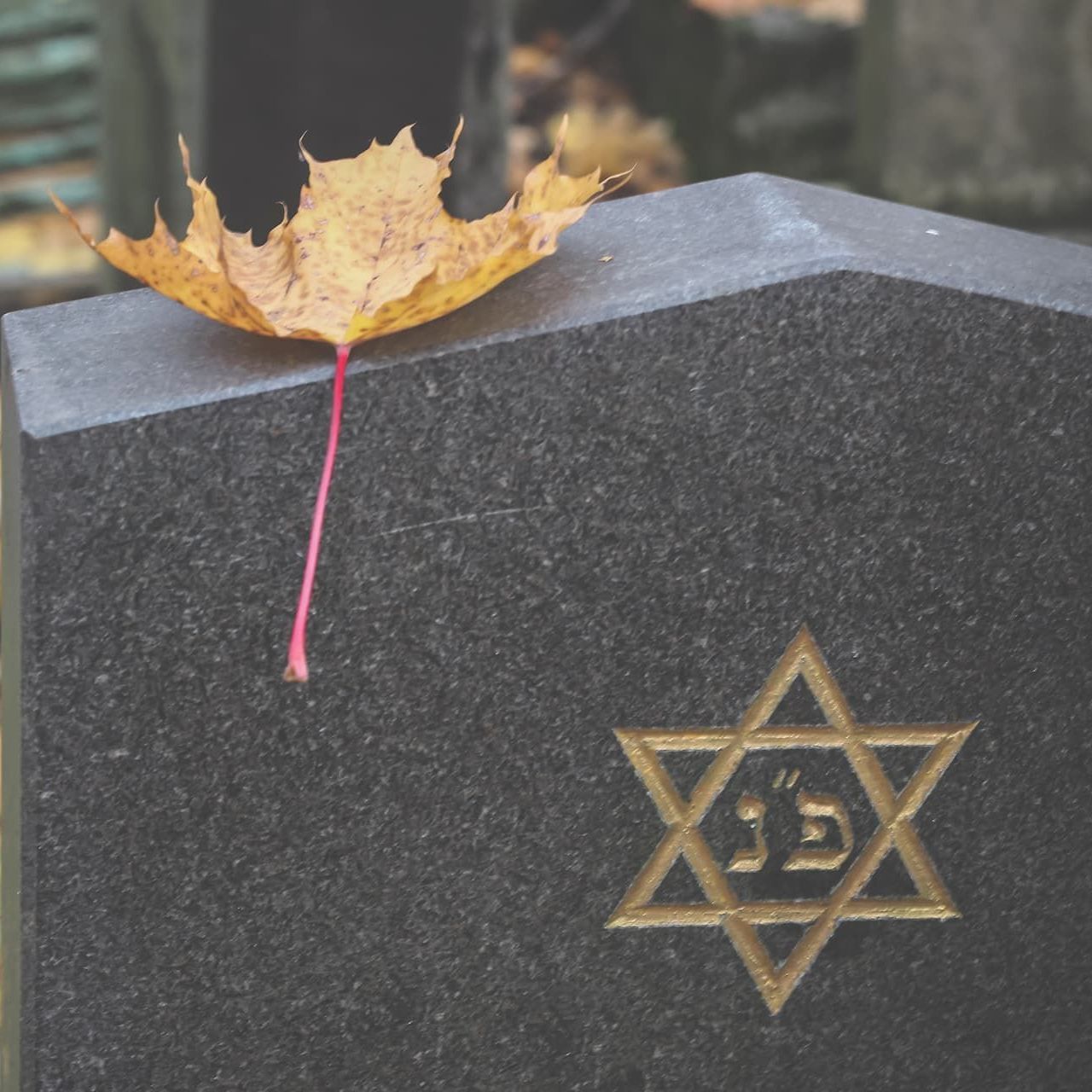 a person praying with a cross on their wrist