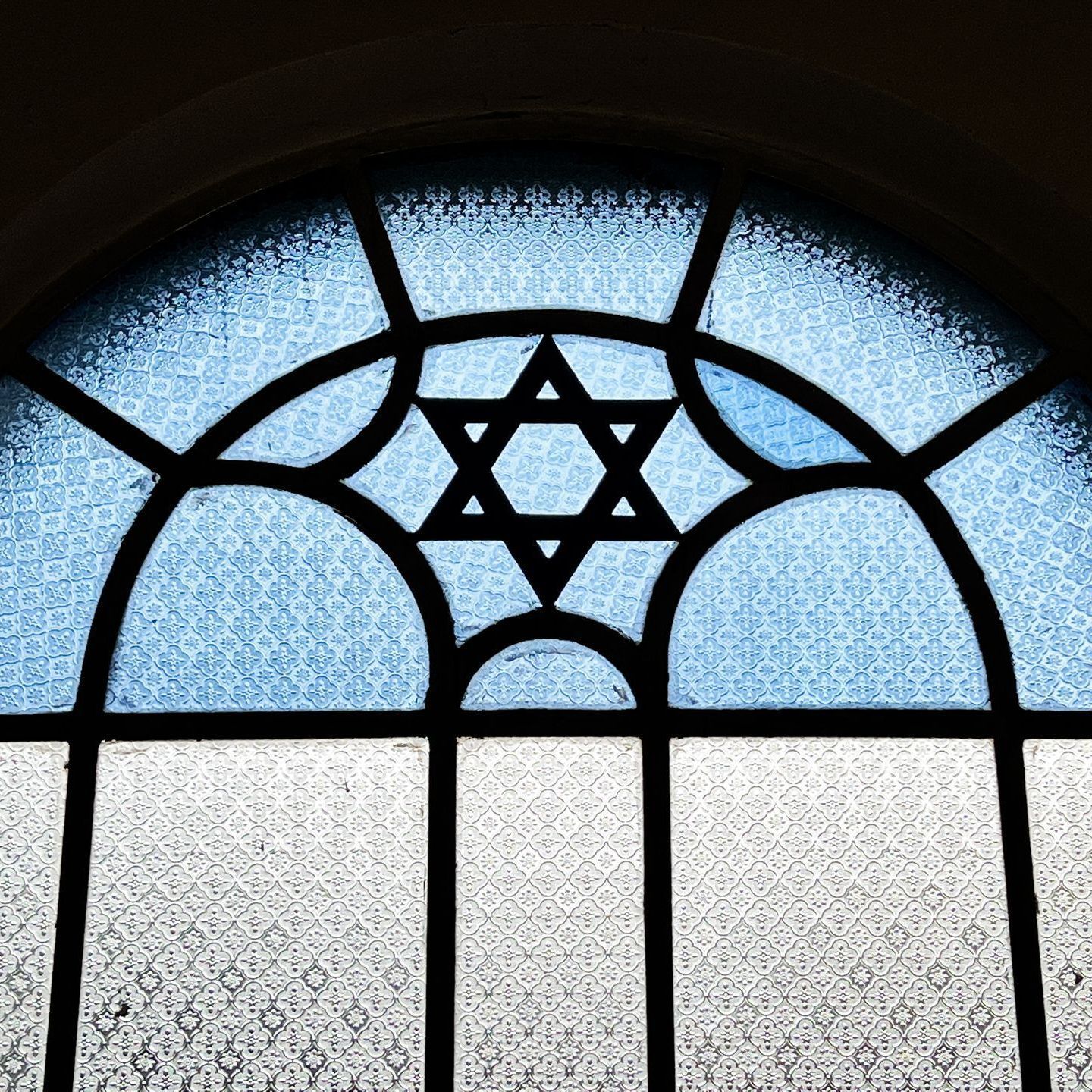 a person praying with a cross on their wrist