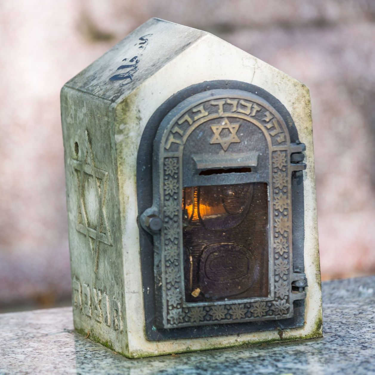 a person praying with a cross on their wrist