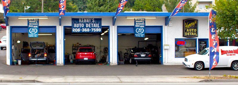 A white truck is parked in front of a car wash