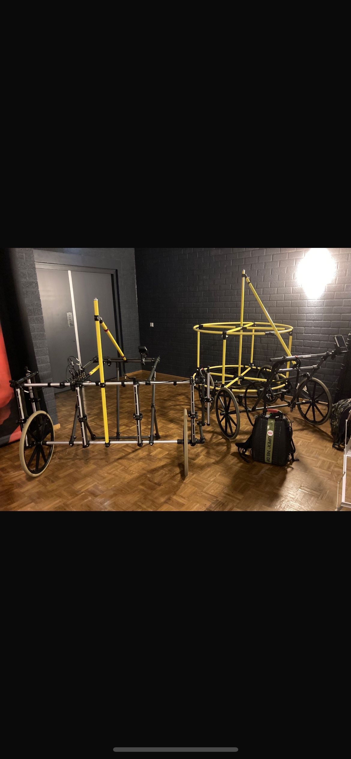 Een sportschool met veel fitnessapparatuur op de vloer.