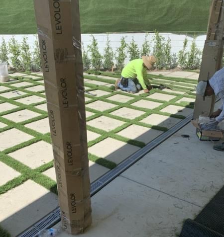 a person is using a drill to install a fence .