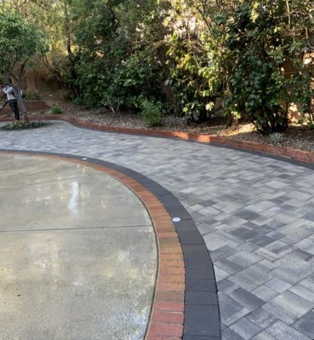 a man is using a drill to drill a hole in a piece of wood .