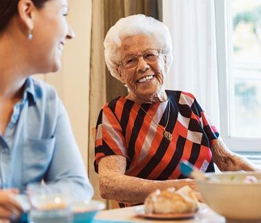 Retirement Living — Happy Senior Woman Talking To a Woman in Glenview, IL