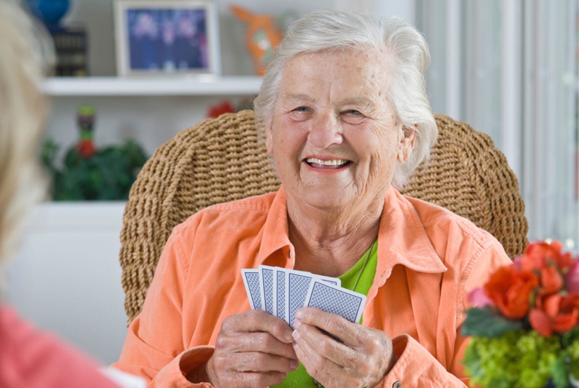 Old Woman Holding a Card While Smilling  — Glenview, IL — Chestnut Square at the Glen