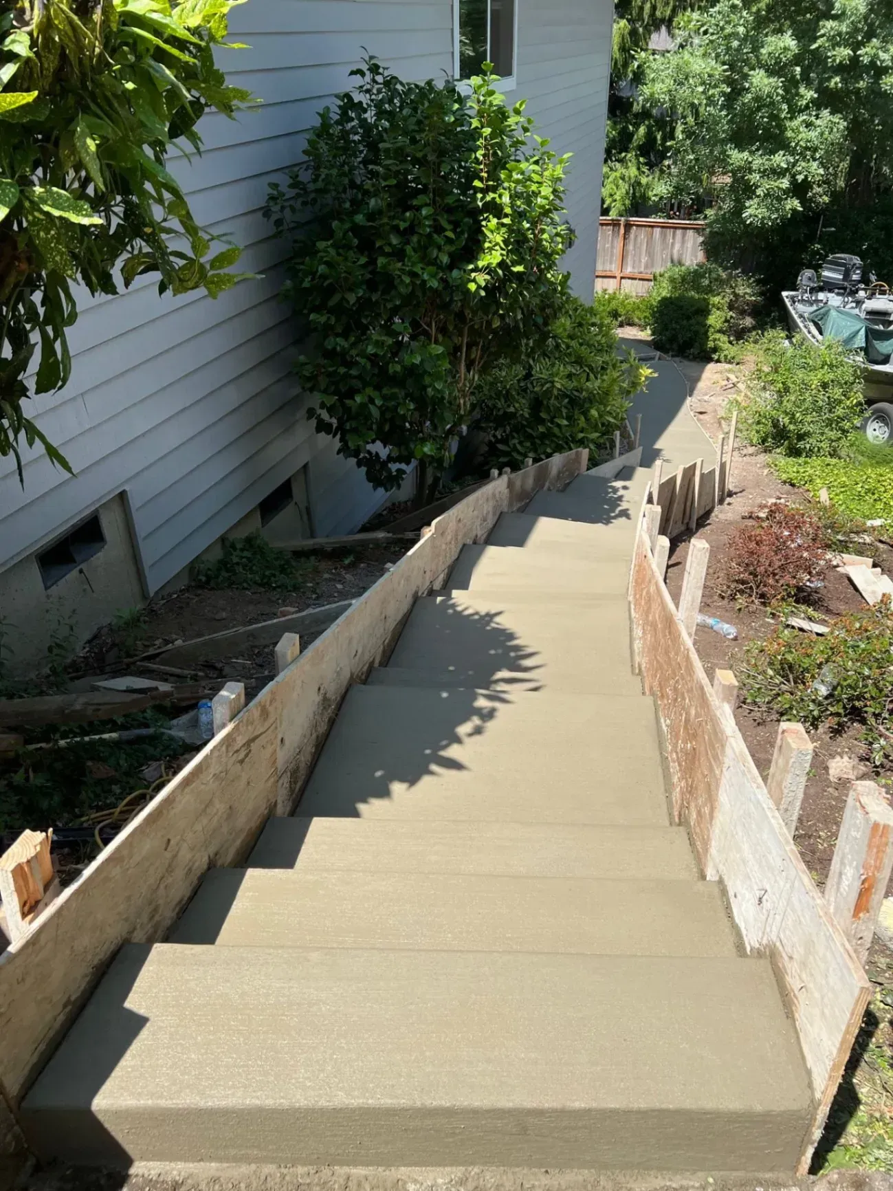 A set of concrete stairs leading up to a house.