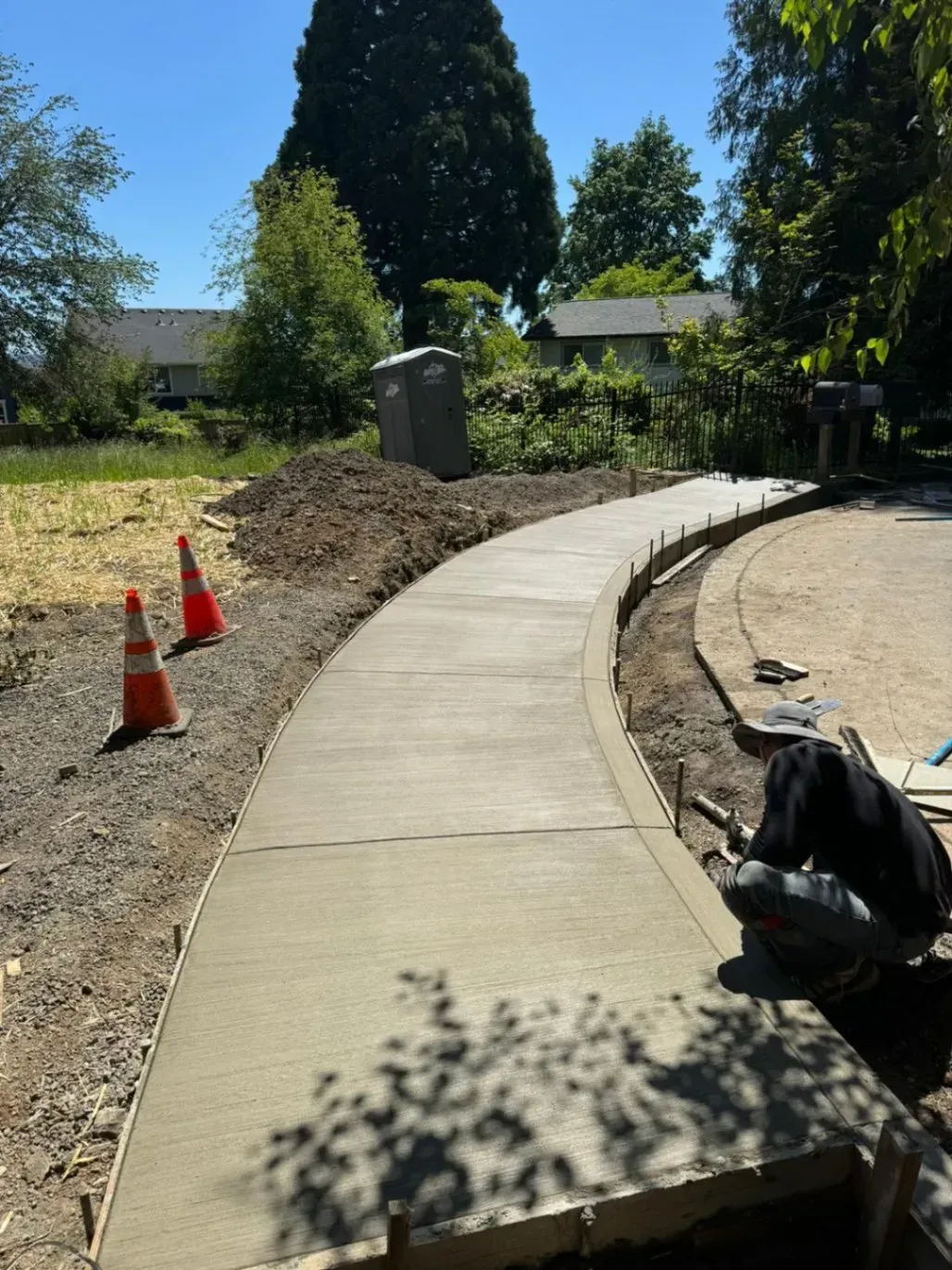 A concrete walkway is being built in a yard.